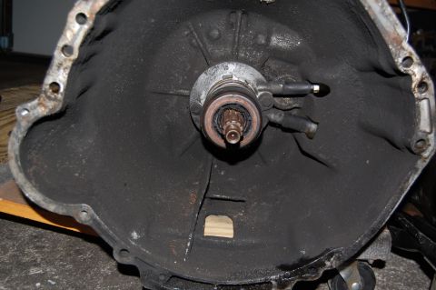 1994 Ford Bronco - Interior view of a vehicle's bell housing, showing the clutch fork and throwout bearing assembly.