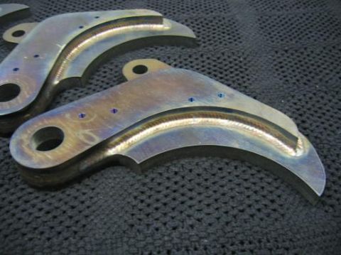 1996 Ford Bronco - Close-up of two custom-welded metal brackets, likely for automotive or industrial use.