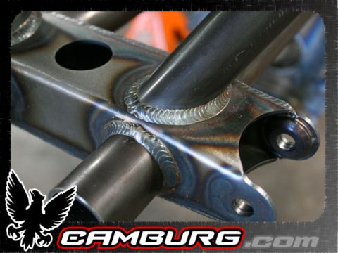 1996 Ford Bronco - Close-up of welded metal frame components, showing heat discoloration and a prominent logo.