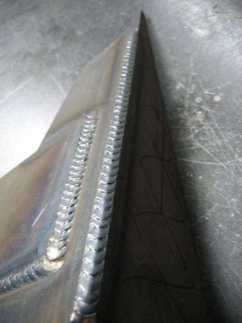 1996 Ford Bronco - This image shows a close-up view of a metal part with distinct weld lines, indicating fabrication or repair work.