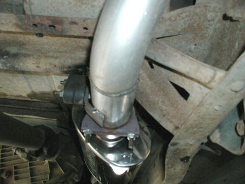 1985 Ford Bronco - Close-up view of a vehicle's exhaust system, showing the pipe and muffler.