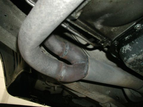 1985 Ford Bronco - Close-up view of a vehicle's exhaust pipe system, a Y-junction and weld marks.