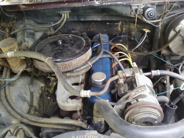 Engine bay with blue engine block, air filter, and hoses. SuperMotors logo visible