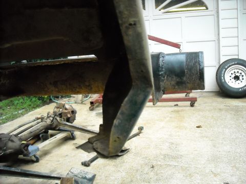 1979 Ford F-150 - Various rusted truck frame and suspension parts are visible, including a tire in the background.