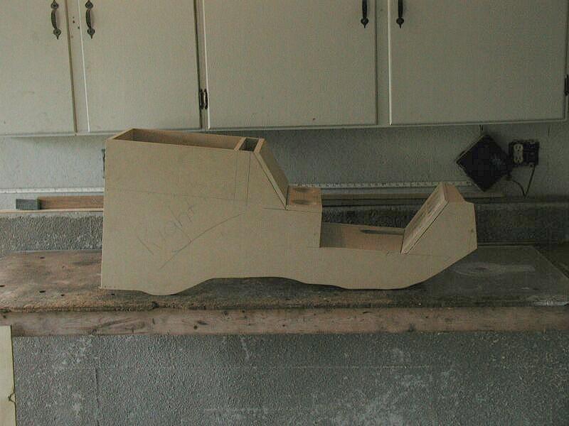Cardboard center console mockup on a garage workbench
