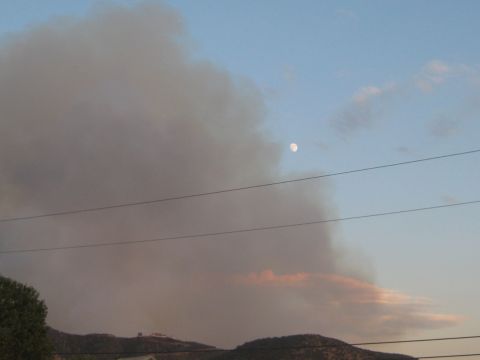 1996 Ford Bronco - A large smoke plume dominates the sky, with the moon visible in the distance. Power lines are strung across the scene.