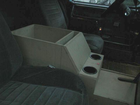 1985 Ford Bronco - A custom wooden center console with cup holders is installed in the interior of a vehicle.