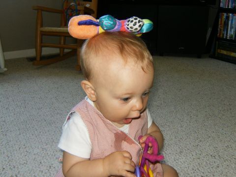 2000 Ford E350 - Baby with a toy caterpillar on its head and holding another toy.