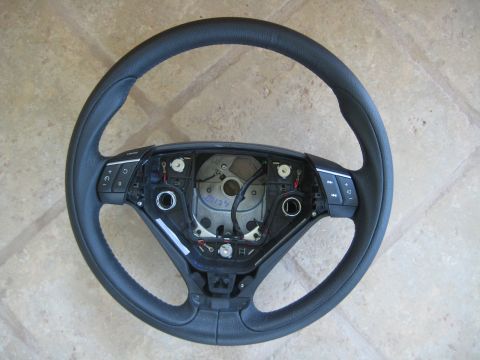 1993 Ford Probe - A black steering wheel is shown from the front, revealing its internal components and wiring.