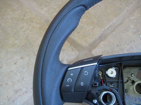 1993 Ford Probe - Close-up of a steering wheel part showing cruise control buttons and wiring.