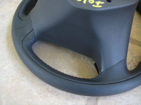 1993 Ford Probe - Close-up of a black steering wheel, showing stitching and handwritten yellow markings.