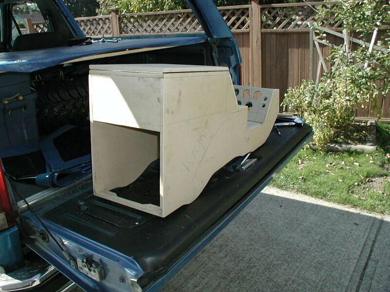 Wooden center-console enclosure under construction sitting on a truck tailgate