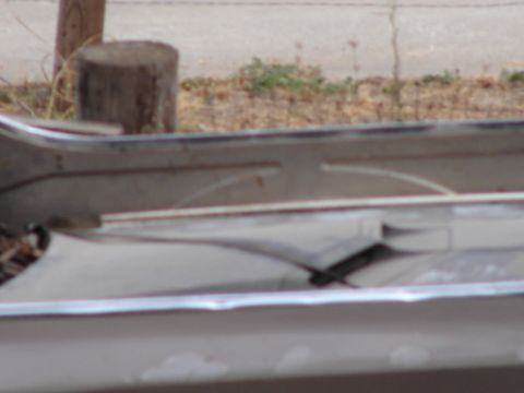 1973 Ford Ranchero - A close-up view of a vehicle's front bumper and surrounding bodywork, showing chrome trim.