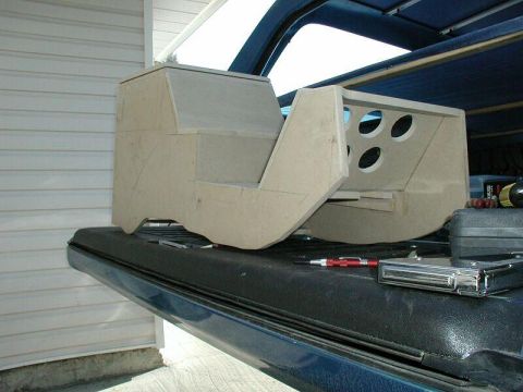 1985 Ford Bronco - Custom center console part, likely for a truck or SUV, sits on a truck bed.