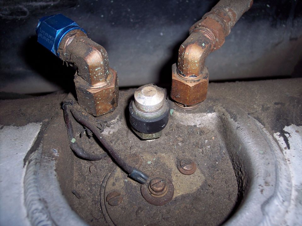 Close-up of a fuel sending unit with two copper lines connected