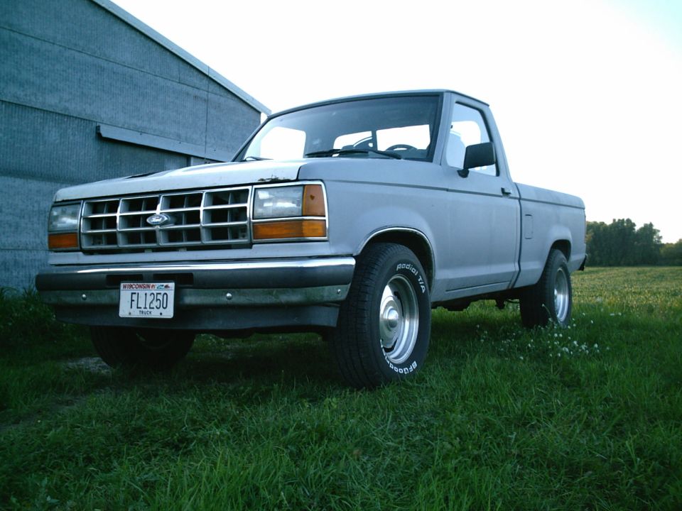 Light blue pickup truck, 3q-front view. License plate reads FL1250