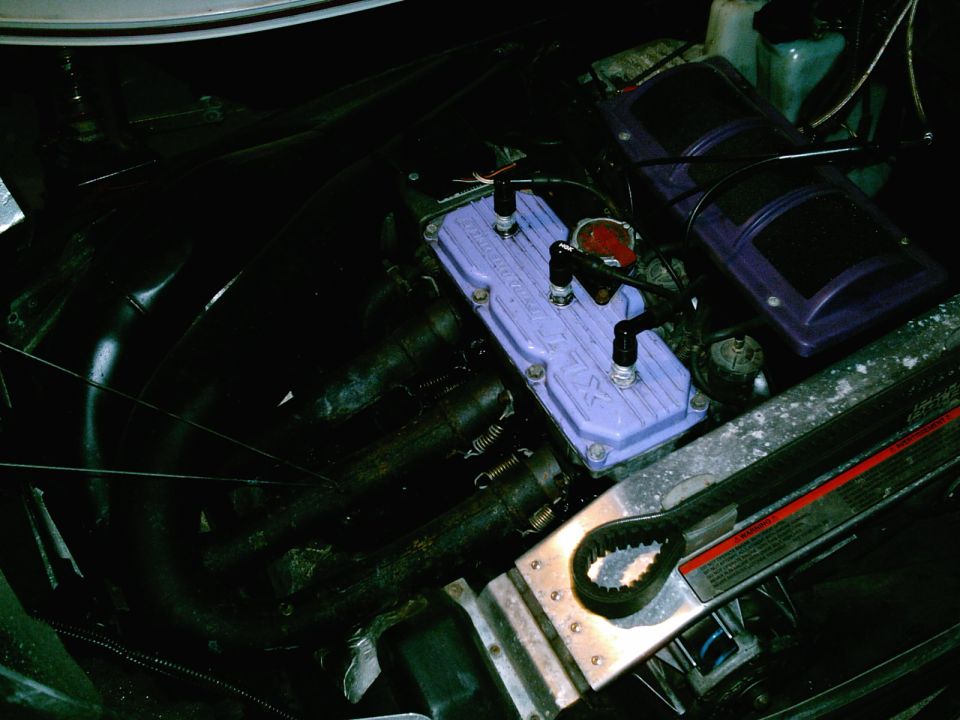 Snowmobile engine with purple valve cover and spark plug wires