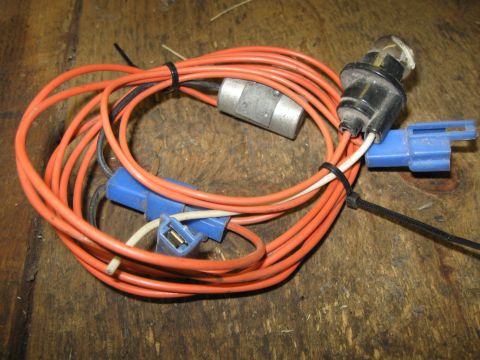 1979 Chevrolet Camaro - A close-up view of an automotive wiring harness with a bulb socket and connectors.