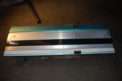 1994 Ford Bronco - A detached Ford door panel is shown lying on a dark surface.
