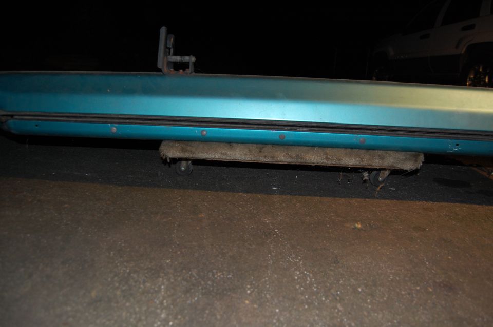 teal vehicle door sill with a roller support underneath