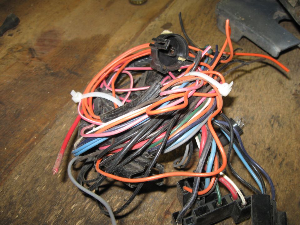 Tangled wiring harness with orange, black, and blue wires