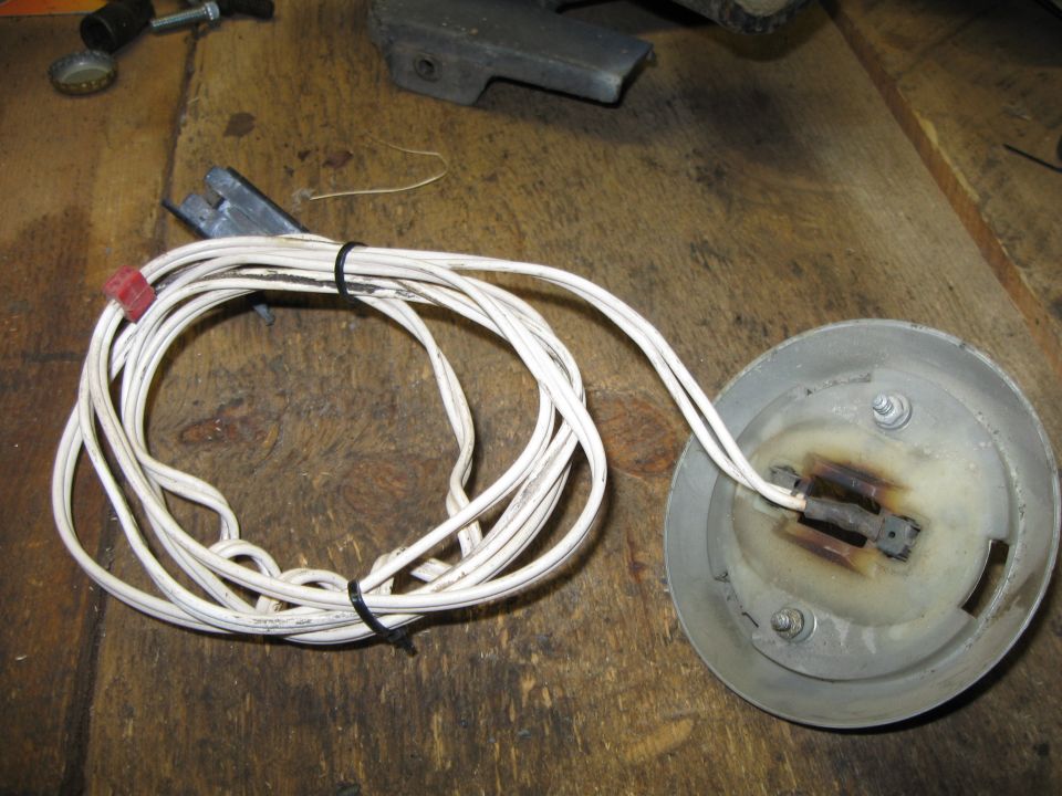 Wire harness connected to a round metal part with electrical contacts