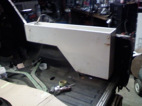 1979 Ford Bronco - A white storage box is being installed in the cargo area of a vehicle, with various tools and materials visible.
