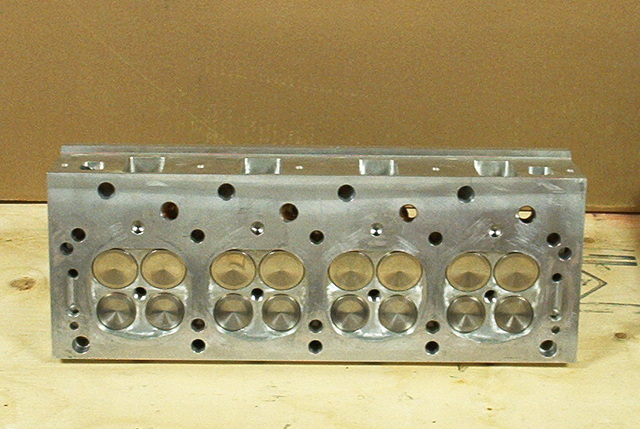 Aluminum engine cylinder head with 32 valves visible