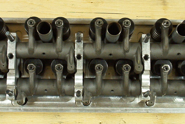 Close-up of an engine's valve train with rocker arms and springs