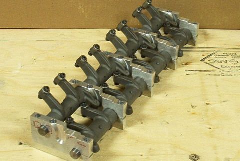 1972 Ford Ranchero - Multiple metal rocker arms are arranged in a line on a wooden surface, with a website address visible in the lower right corner.
