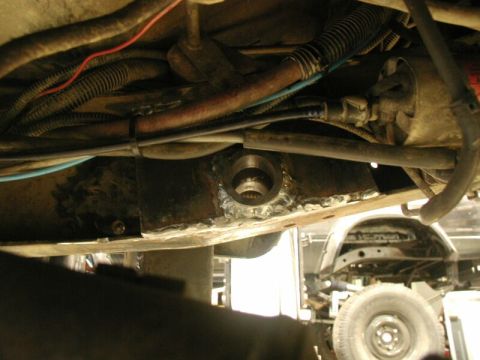 1985 Ford Bronco - Close-up of modified vehicle undercarriage, showing recent welding work and various mechanical parts.