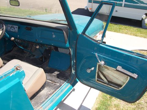1970 Jeep Jeepster - Interior of a 1970 Jeep Jeepster, showing the dashboard and driver's side door.