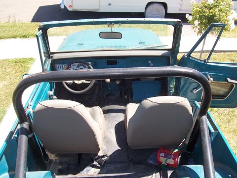 1970 Jeep Jeepster - View of the interior of a vintage Jeep, showing the seats, steering wheel, and dashboard.