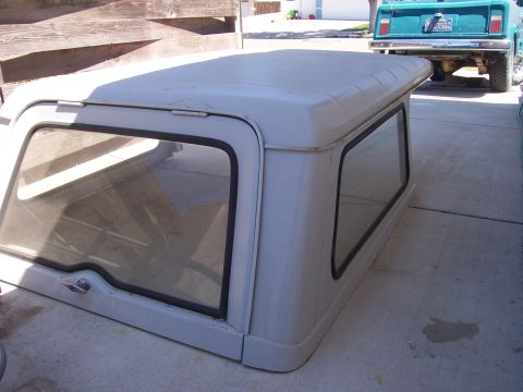1970 Jeep Jeepster - A white hardtop with tinted windows is shown, with a teal Jeep in the background.
