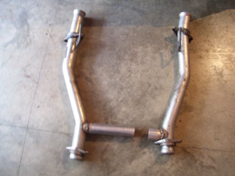 1990 Ford Mustang - Pair of exhaust pipes shown with the Supermotors logo visible at the bottom right.