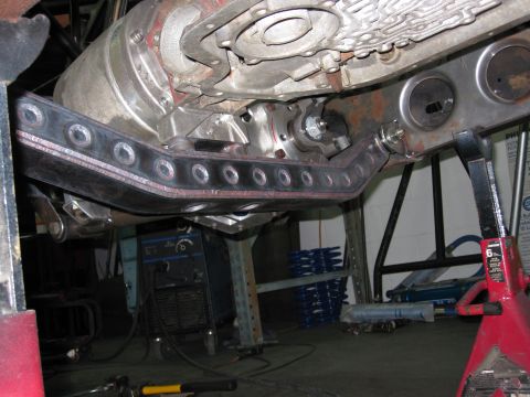 1995 Ford Bronco - Close-up of vehicle undercarriage with transmission and skid plate visible.