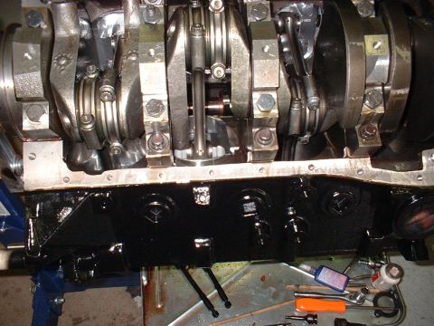 1956 Ford Crown Victoria - Close-up view of an engine's crankshaft and connecting rods, with the oil pan in place.