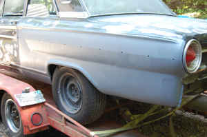 1964 Ford Fairlane - Rear view of a 1964 Ford Fairlane being transported on a trailer.