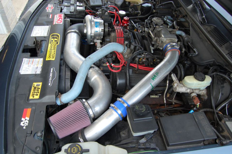 Engine bay with turbocharger, K&N air filter, and custom intake piping