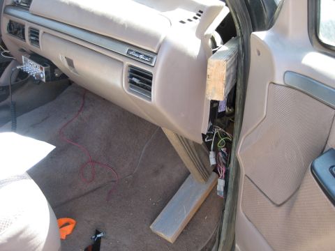 1995 Ford Bronco - Dashboard and interior of a 1995 Ford Bronco with wiring exposed and braced with wood.