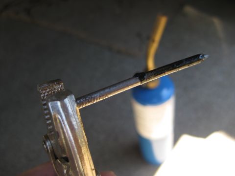 1995 Ford Bronco - Tool setup for a repair, possibly involving heat application to a metal part.
