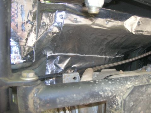 1996 Ford Bronco - Close-up of heat shield insulation, likely related to a vehicle's exhaust system.