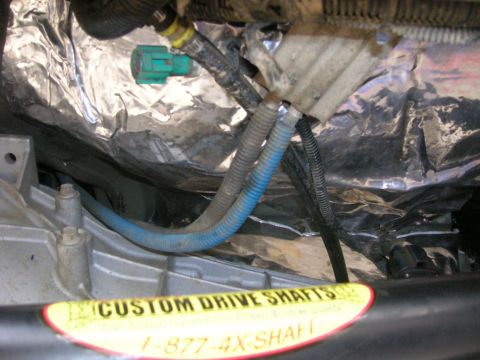 1996 Ford Bronco - Undercarriage view shows drive shaft components and a sticker for 'Custom Drive Shafts'.