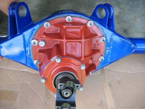1992 Ford Mustang - Close-up of a Ford rear axle differential housing, painted red and blue, with visible casting marks.