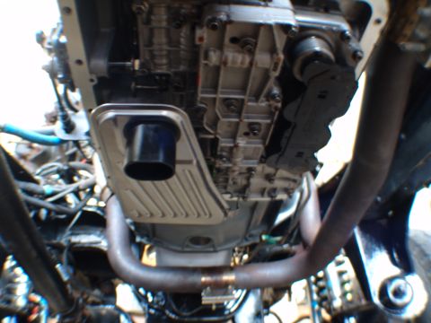 1996 Ford Bronco - Underside view shows the transmission pan and exhaust pipes of a vehicle.