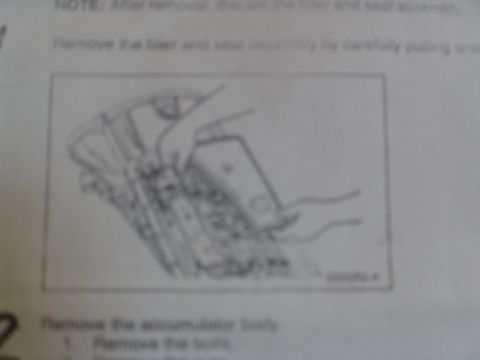 1996 Ford Bronco - Diagram illustrates the process of removing a transmission filter and seal assembly, with accompanying text detailing the steps.