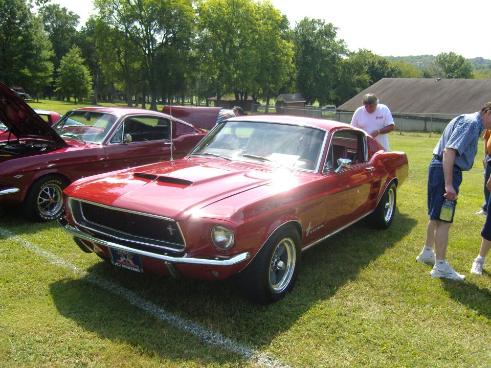 Red 1967 Ford Mustang coupe with hood scoop and chrome grille
