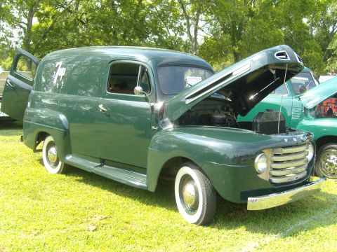 2007 Ford Mustang - Vintage green panel van parked on grass, hood and driver's door open.