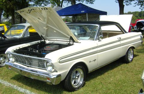 2007 Ford Mustang - White 1963 Ford Falcon coupe with black vinyl roof, hood and trunk open, parked outdoors.