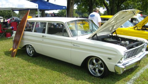 2007 Ford Mustang - A white station wagon, identified as a Falcon, is displayed with its hood open and a surfboard propped against its side.